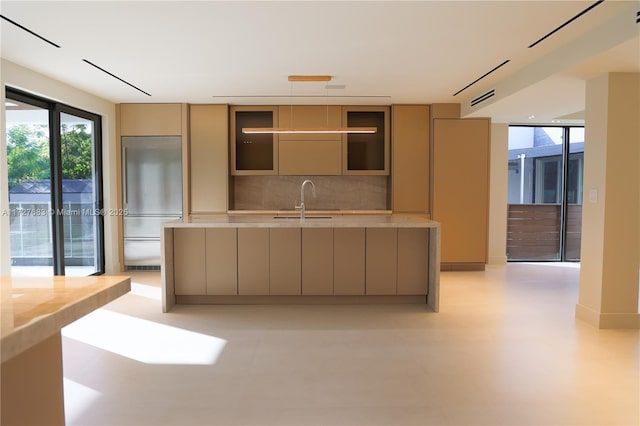 kitchen with sink, stainless steel built in refrigerator, and decorative backsplash