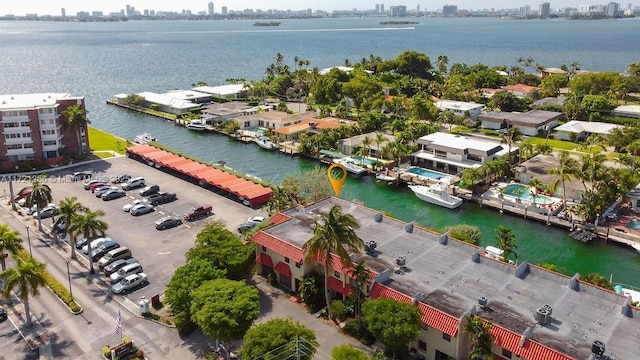 birds eye view of property featuring a city view and a water view