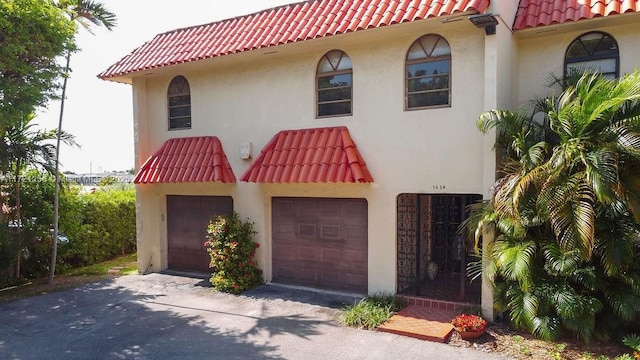 mediterranean / spanish-style home featuring a garage