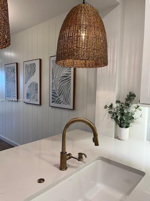 room details featuring wooden walls and sink