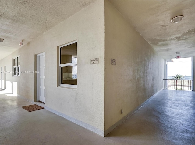 hallway with concrete floors