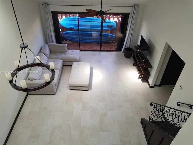 living room featuring ceiling fan and tile patterned floors