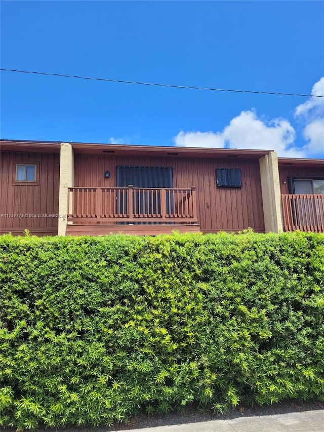 view of front facade featuring a balcony and board and batten siding