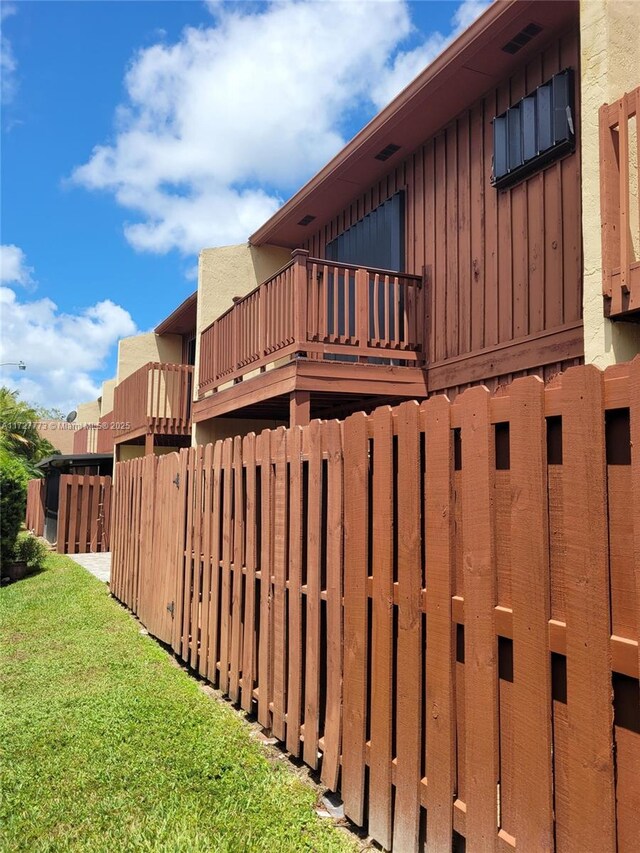 view of side of property with fence and board and batten siding