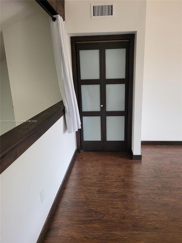 hall with dark hardwood / wood-style flooring