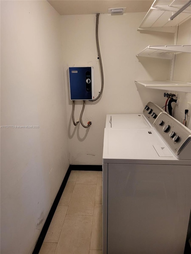 laundry room with light tile patterned floors, baseboards, laundry area, and independent washer and dryer