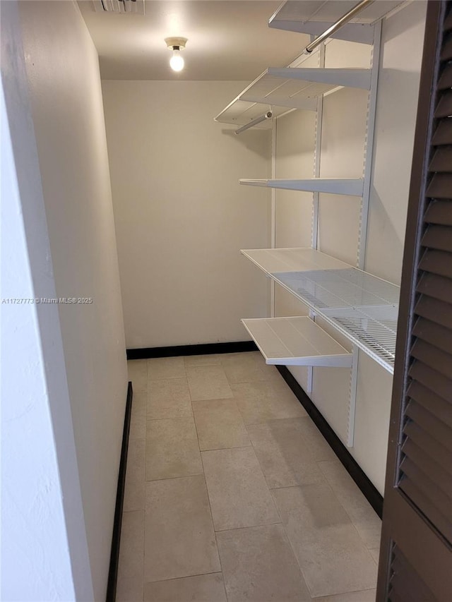 walk in closet with visible vents