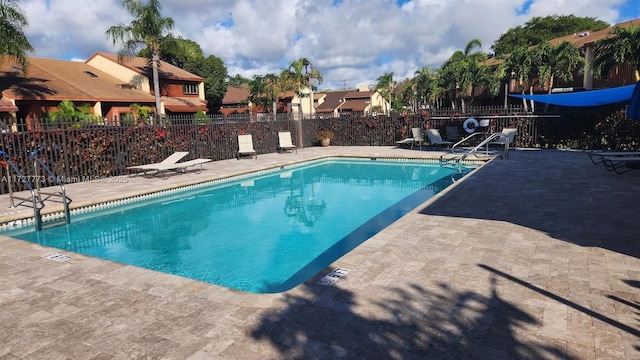 pool featuring a patio and fence