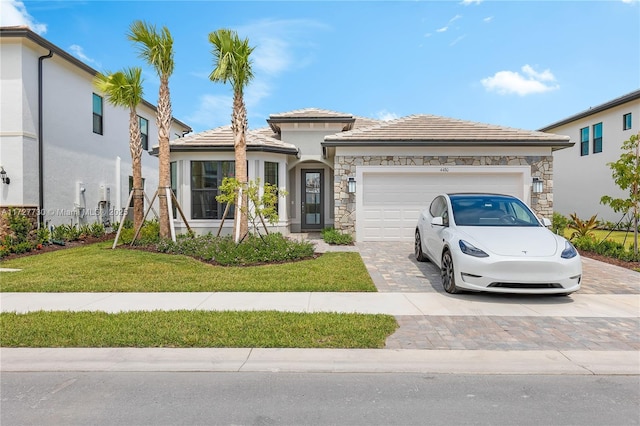 view of front of property with a front yard and a garage