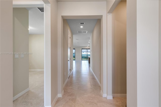 corridor with light tile patterned floors