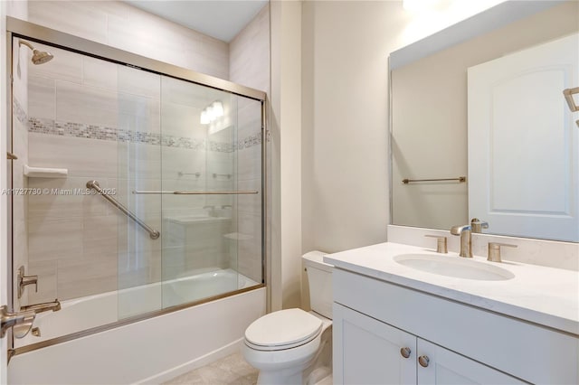 full bathroom featuring toilet, bath / shower combo with glass door, and vanity