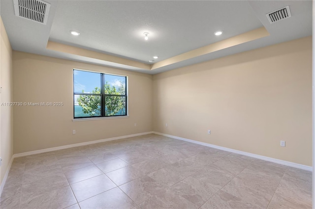 empty room with a tray ceiling