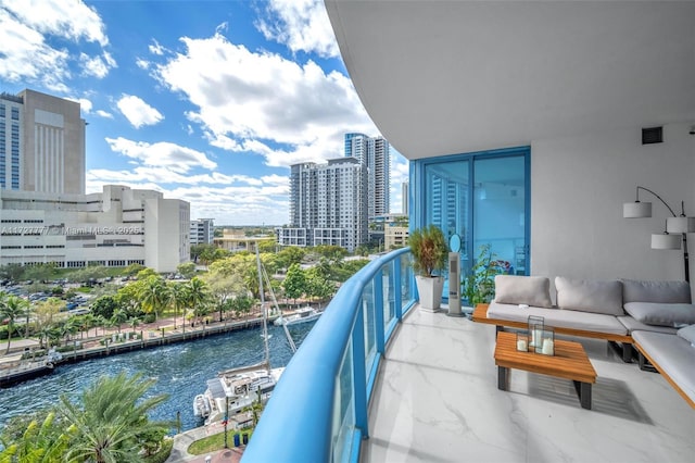 balcony featuring a water view and outdoor lounge area