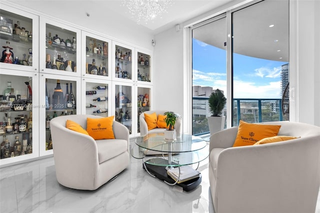 living area featuring expansive windows and a notable chandelier