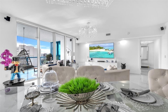 living room featuring expansive windows and a chandelier