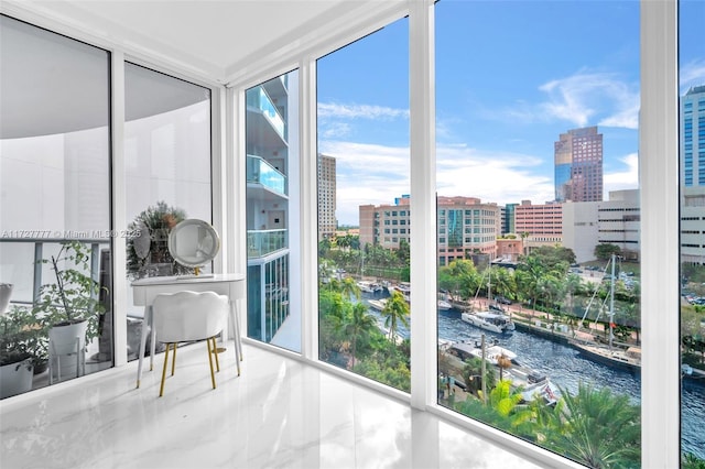 sunroom / solarium featuring a wealth of natural light and a water view