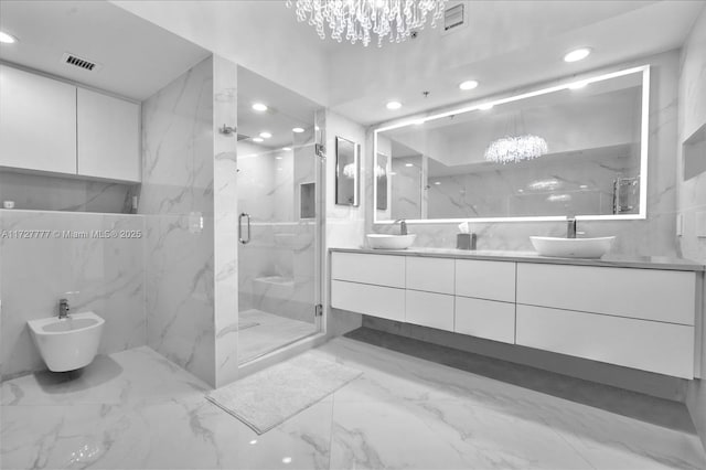 bathroom with a bidet, vanity, a shower with door, and a notable chandelier