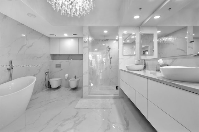 full bathroom with vanity, tile walls, an inviting chandelier, a bidet, and independent shower and bath