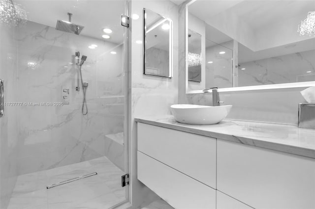 bathroom featuring walk in shower and vanity