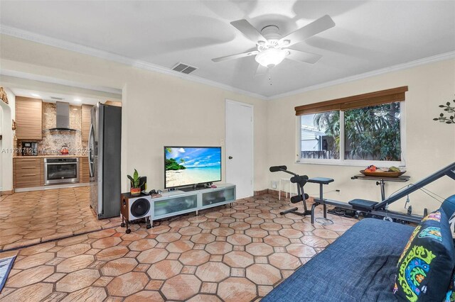 workout area featuring crown molding and ceiling fan