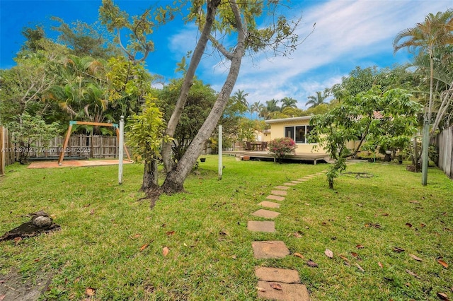 view of yard with a wooden deck and a playground