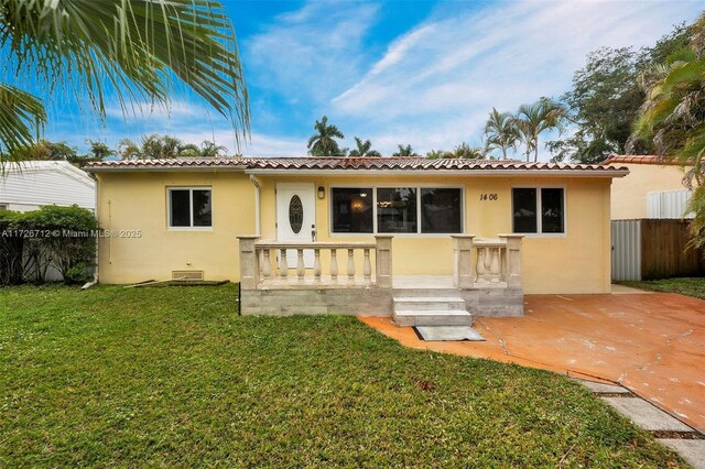 view of front of house with a patio area and a front lawn