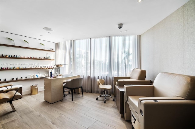 bar with a wall of windows and light hardwood / wood-style floors