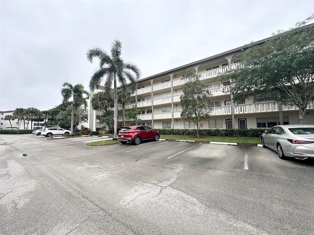 view of building exterior with uncovered parking