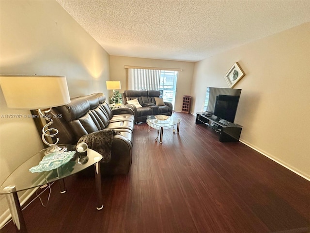 living room with a textured ceiling and dark hardwood / wood-style flooring