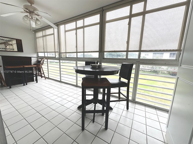 sunroom featuring ceiling fan and a wealth of natural light