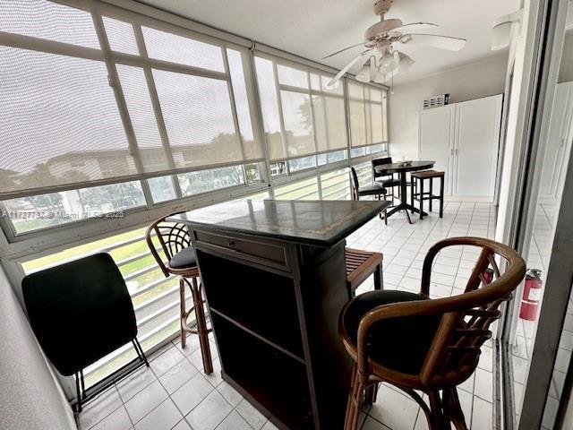 sunroom / solarium with ceiling fan and plenty of natural light