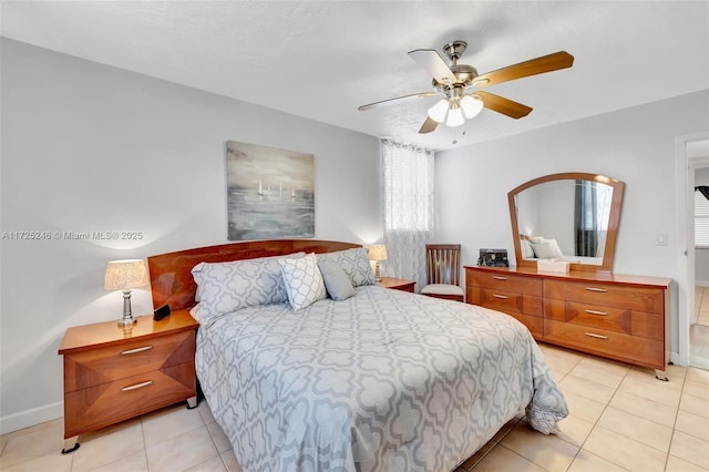 tiled bedroom featuring ceiling fan