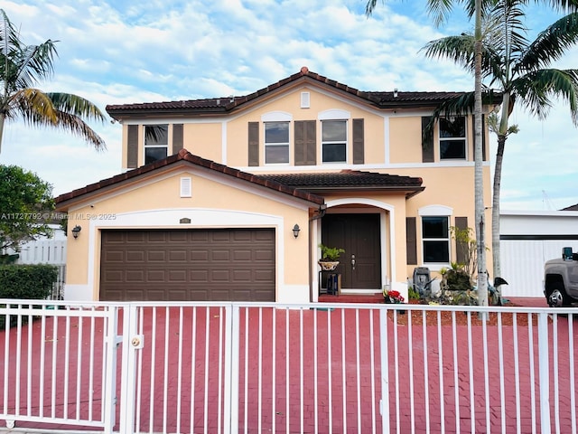 mediterranean / spanish house featuring a tiled roof, driveway, a fenced front yard, and stucco siding