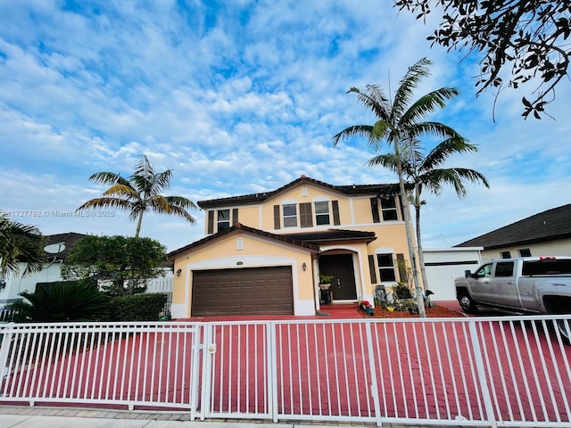 view of front of property featuring a fenced front yard, a garage, and stucco siding