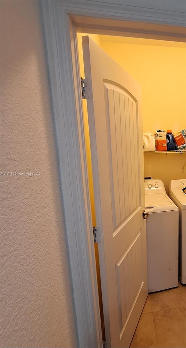 washroom with washer and clothes dryer, laundry area, crown molding, and a textured wall