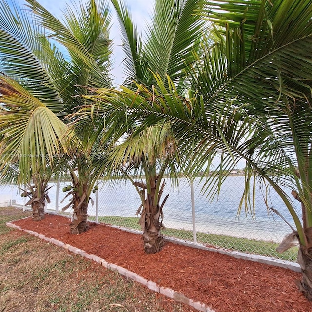 property view of water featuring fence