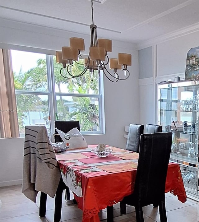 dining room featuring an inviting chandelier, light tile patterned flooring, and ornamental molding