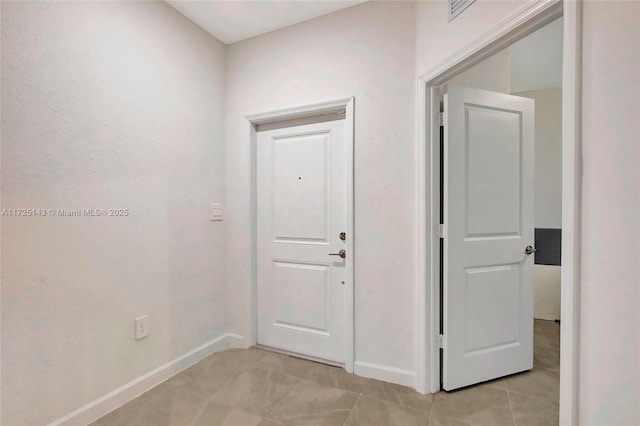 hall with light tile patterned floors