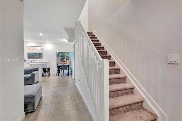 stairs with tile patterned floors