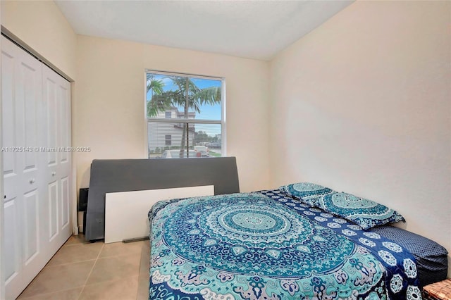 tiled bedroom featuring a closet