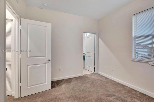 unfurnished bedroom with light carpet