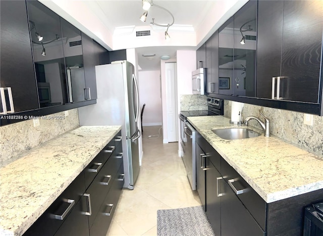 kitchen featuring light stone counters, ornamental molding, stainless steel appliances, and sink