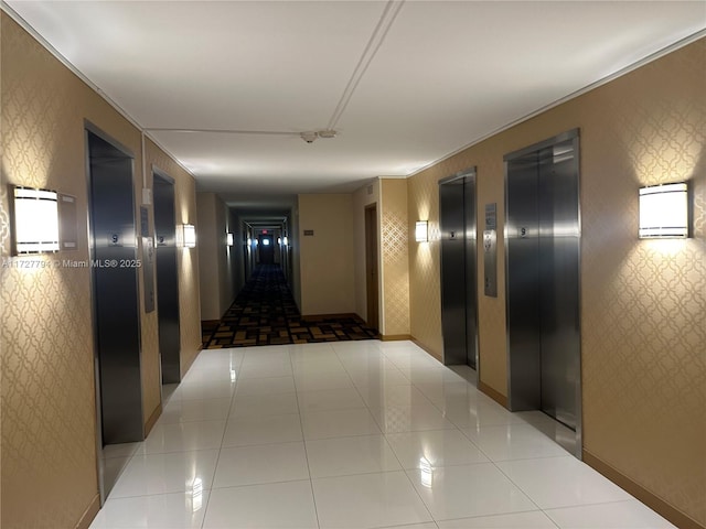 hallway featuring light tile patterned floors and elevator