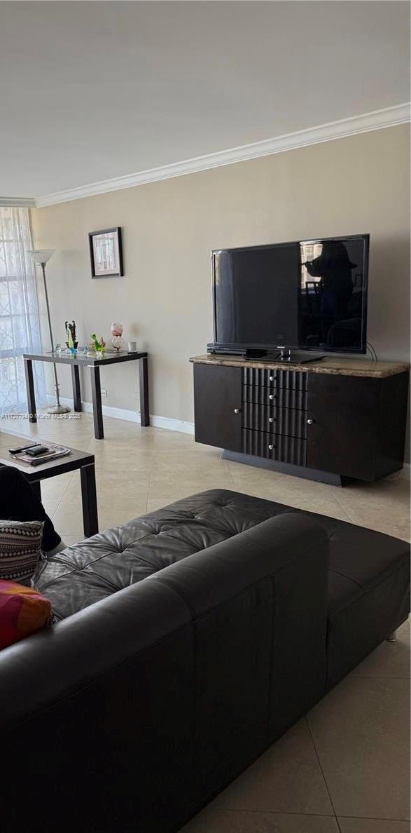 tiled living room with ornamental molding