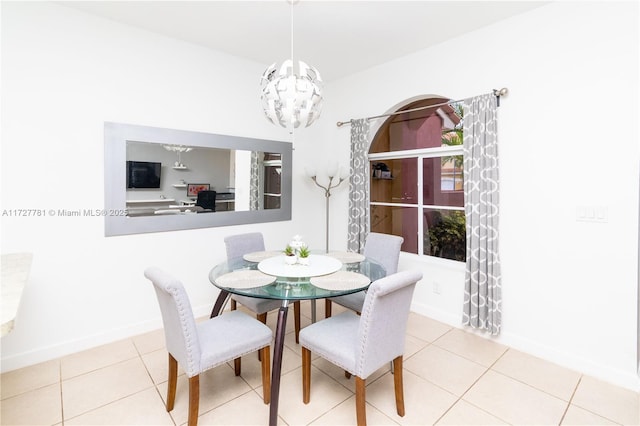 dining room with tile patterned floors and a notable chandelier