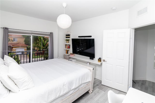 bedroom featuring access to outside and light hardwood / wood-style floors