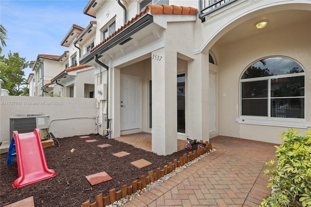 property entrance featuring central AC and a patio area