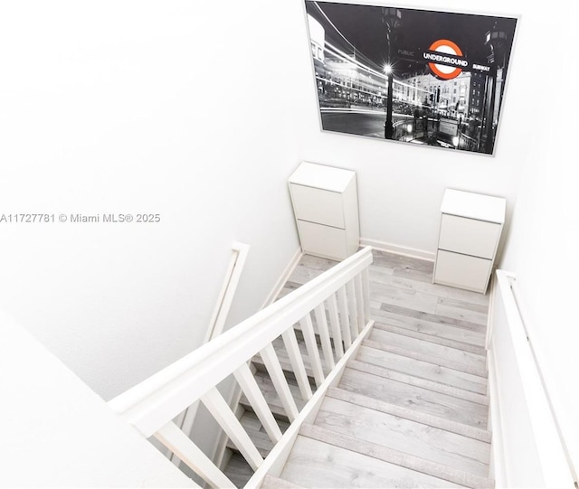 stairway with hardwood / wood-style flooring