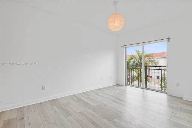 spare room with light hardwood / wood-style floors