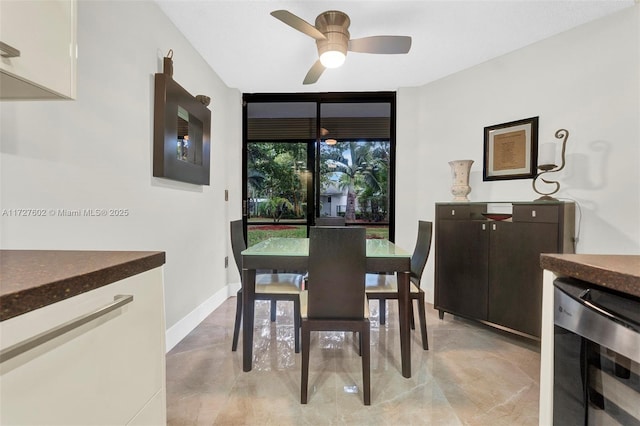 dining space featuring ceiling fan, beverage cooler, and floor to ceiling windows